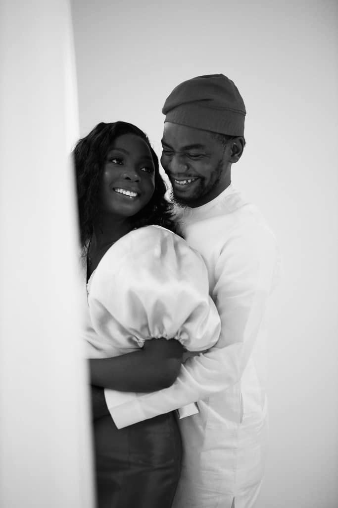 Opeyemi and Chima smiling together in a black and white portrait